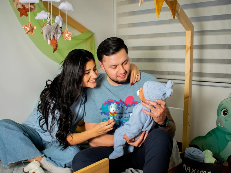 Happy couple holding newborn after IVF success
